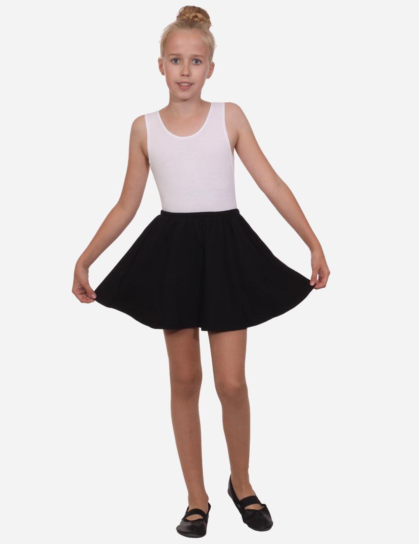 Back view of a flared black skirt and white tank top on a young girl, black ballet flats, isolated on white background.