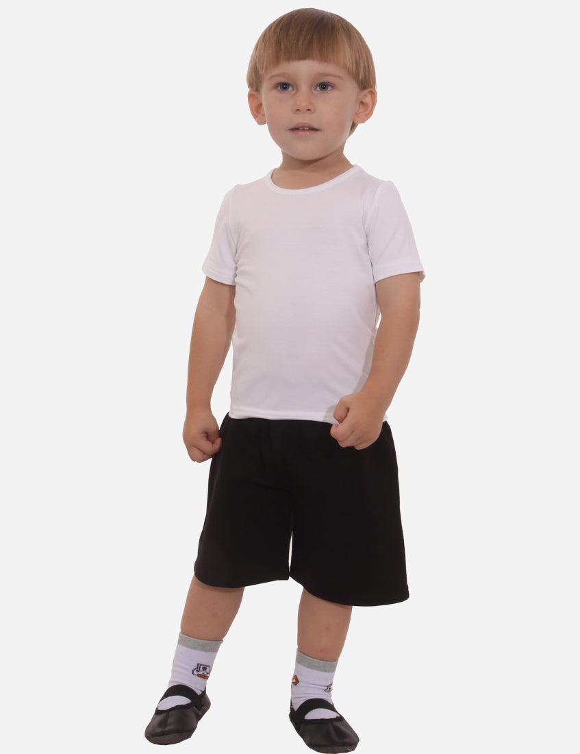 Back view of a little boy wearing white t-shirt and black shorts, black ballet shoes with white socks, isolated on white background.
