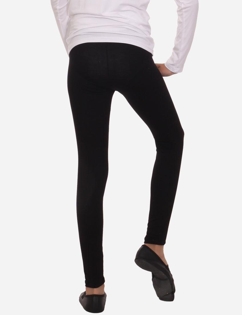 Black children's tights from the back, worn on a girl with a white shirt.