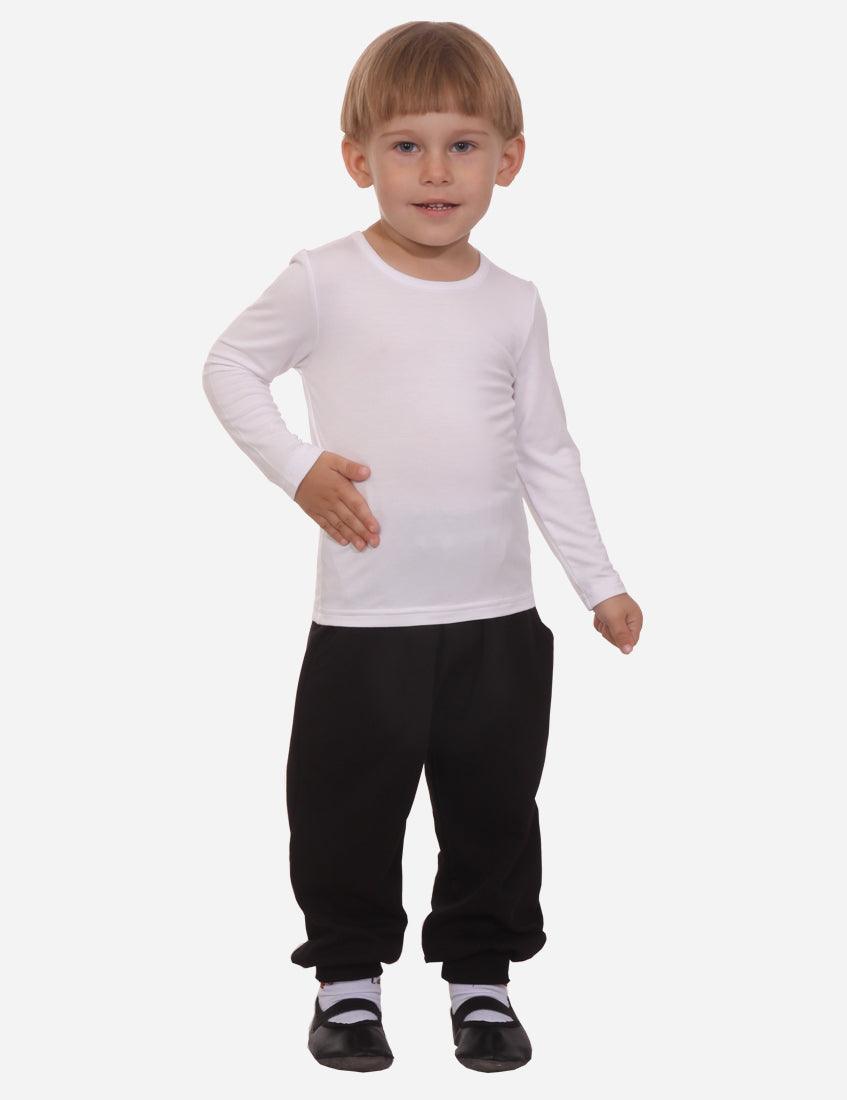 Young boy with blond hair in white long sleeve shirt and black cuffed pants standing front view on white background