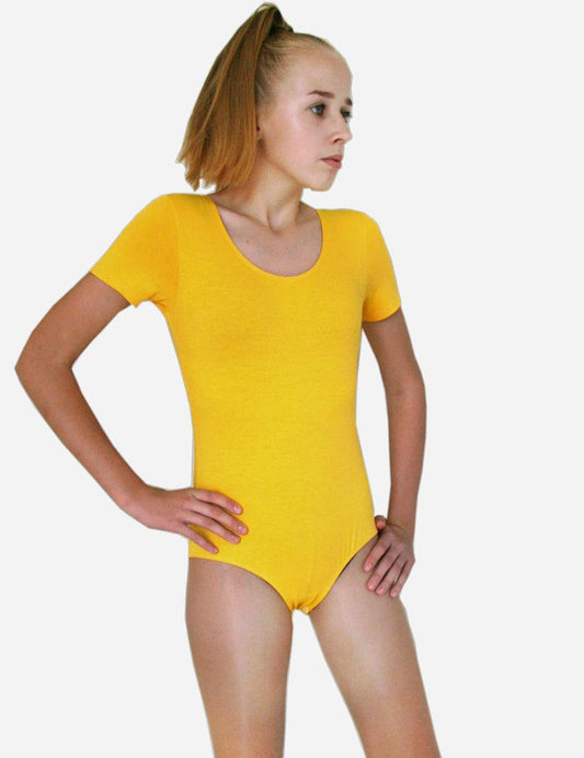 Young female gymnast posing in bright yellow short-sleeved leotard against a white background.