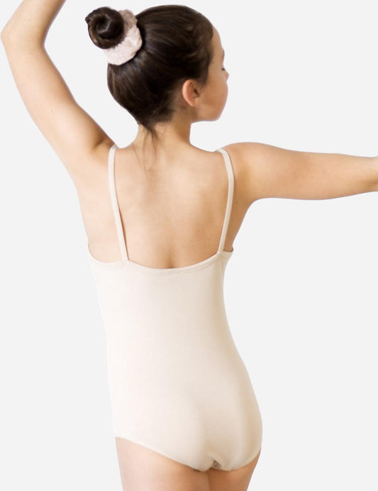 Child ballet dancer in skin-tone strap leotard with hair bun stretching upward from back view