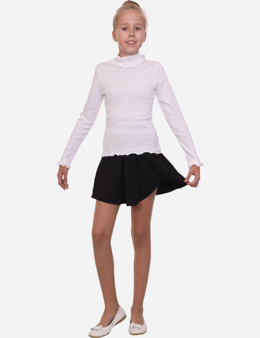 Full-body image of a young girl wearing a white ruffled turtleneck and black skirt, with a neutral background highlighting the outfit.