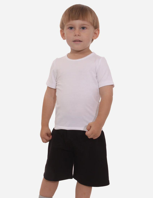 Little boy in a light short-sleeved t-shirt and black shorts, front view, standing on a white background