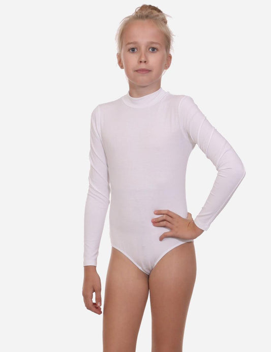 Young girl in a white mock neck leotard with long sleeves, posing with her hand on her hip and ballet slippers.