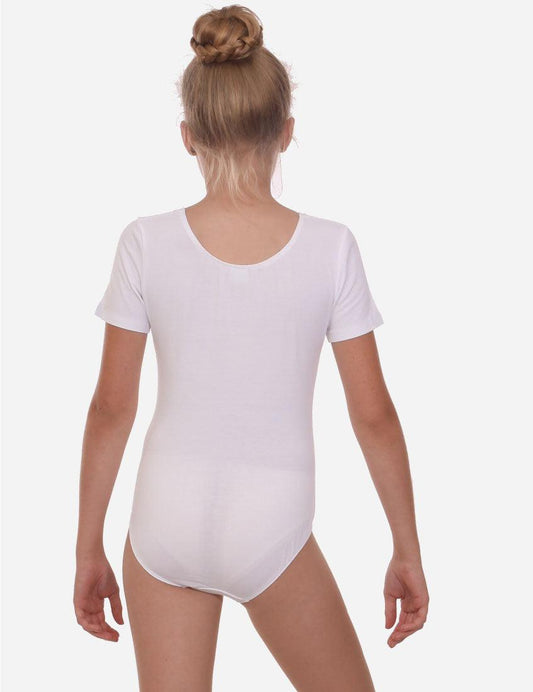 Back view of a young girl in a white short sleeve leotard with her hair in a neat bun, ready for dance class.