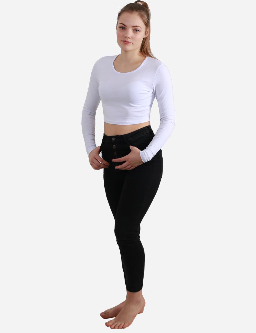 Woman standing in a white crop top with long sleeves paired with black pants, full body on white background