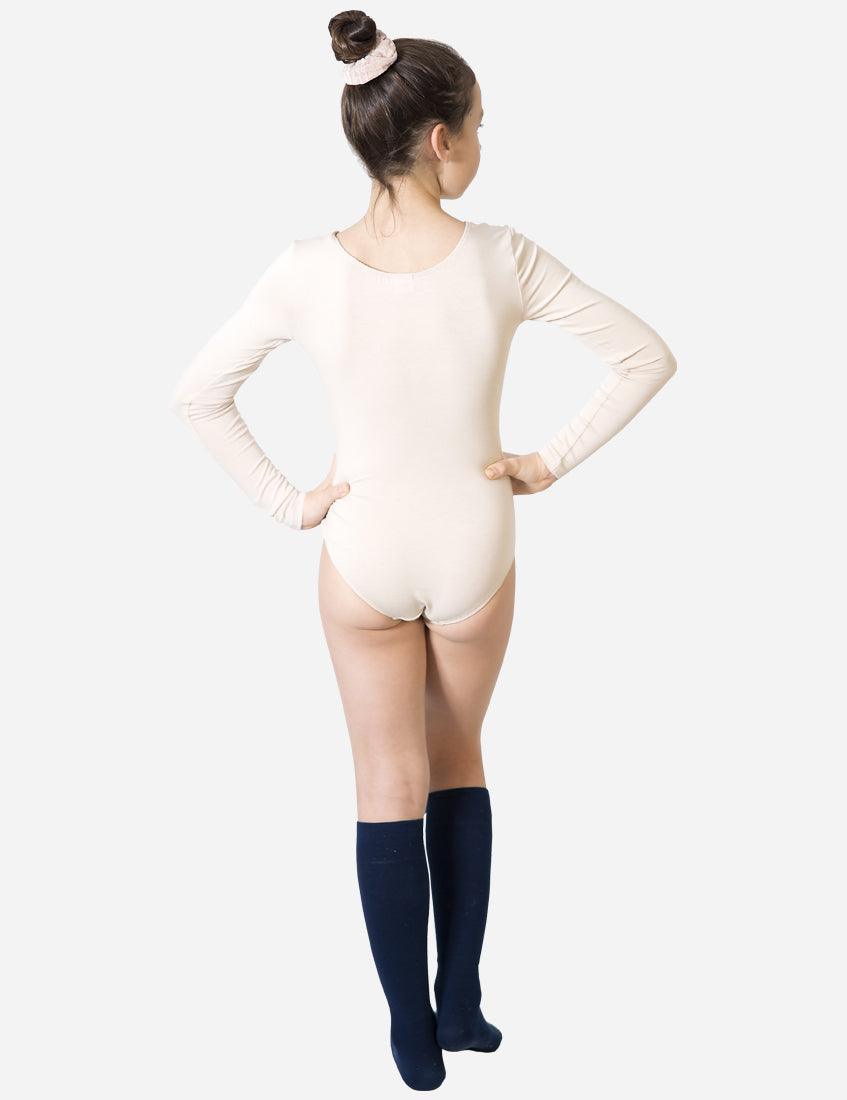 Back view of a young dancer in a skin-tone leotard with navy blue socks preparing for ballet