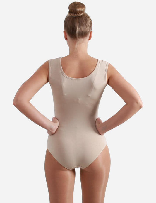 Back view of a female ballet dancer in a sleeveless skin-toned leotard against a plain backdrop.