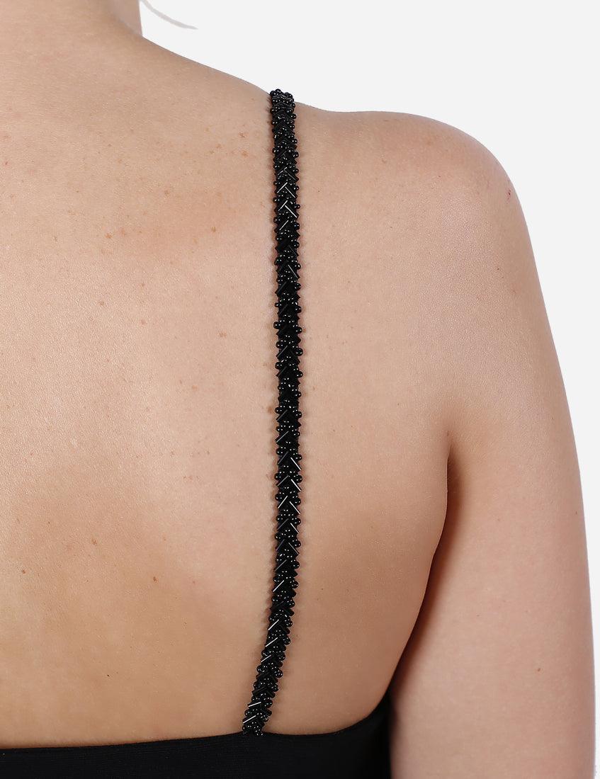 Close-up of the beaded strap detail on an exclusive black dress.